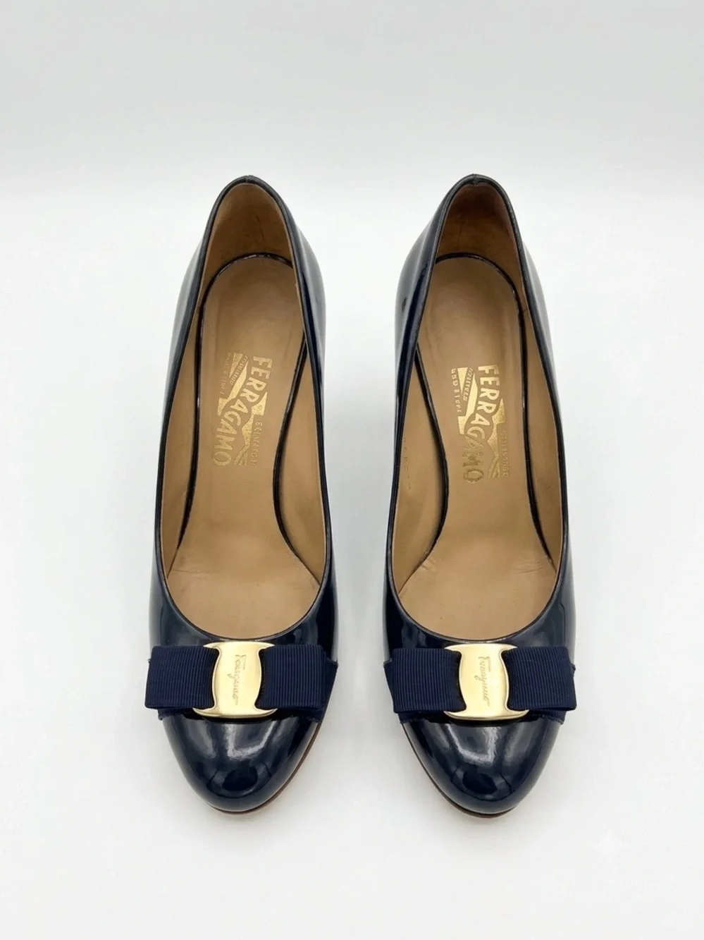 Salvatore Ferragamo Navy Patent Pumps with Navy Bow and Gold Plaque